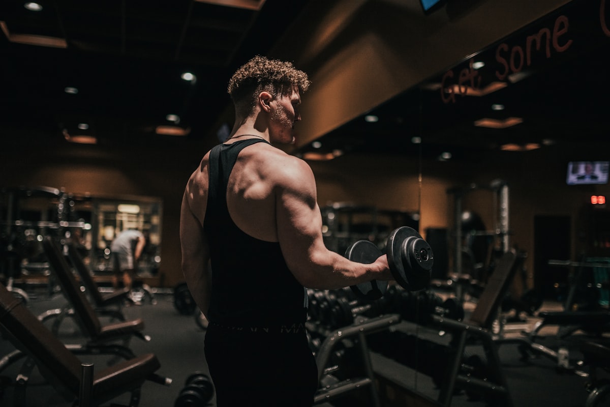 Athlete performing a dumbbell bicep curl in the gym
